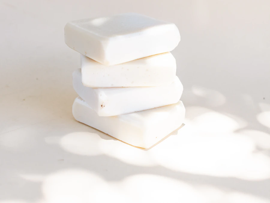 A stack of four cream-coloured bars in dappled afternoon light