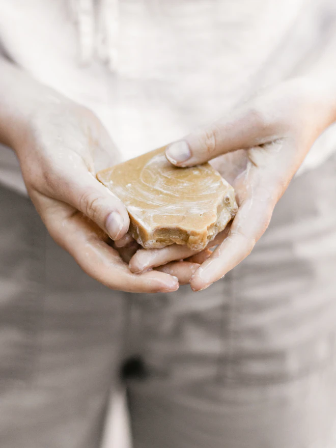 Two hands cupping a swirled bar of soap