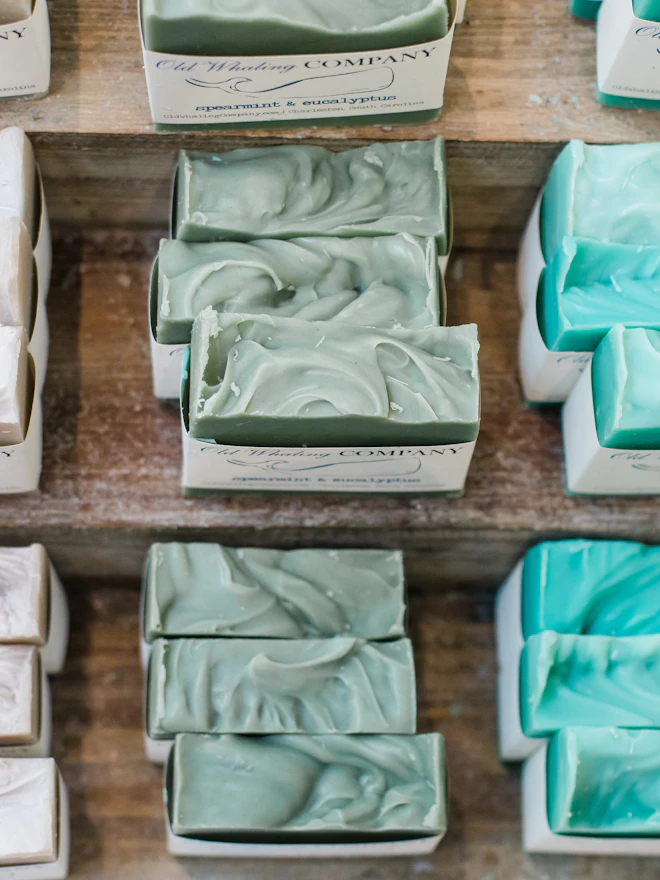 Rows of fresh green soap curing on wooden racks
