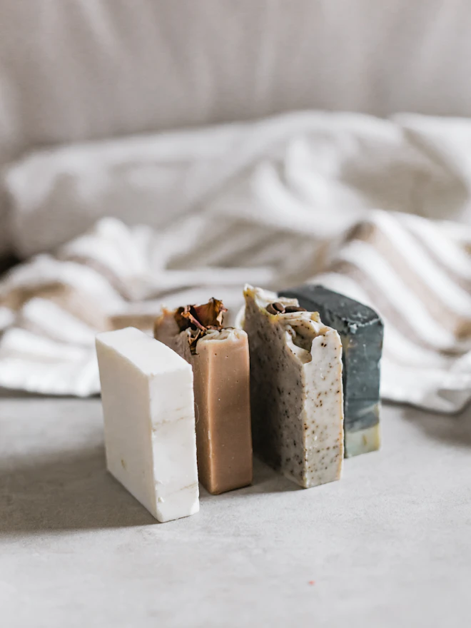 Four bars stood on end against rumpled white linen
